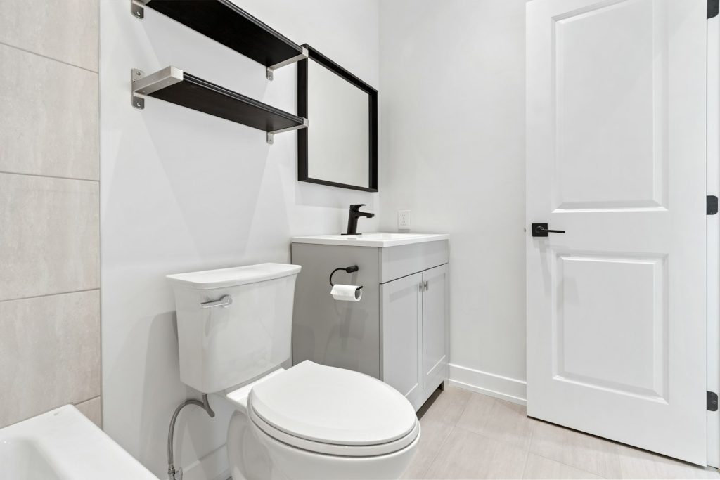 White two-piece toilet in a clean, modern bathroom